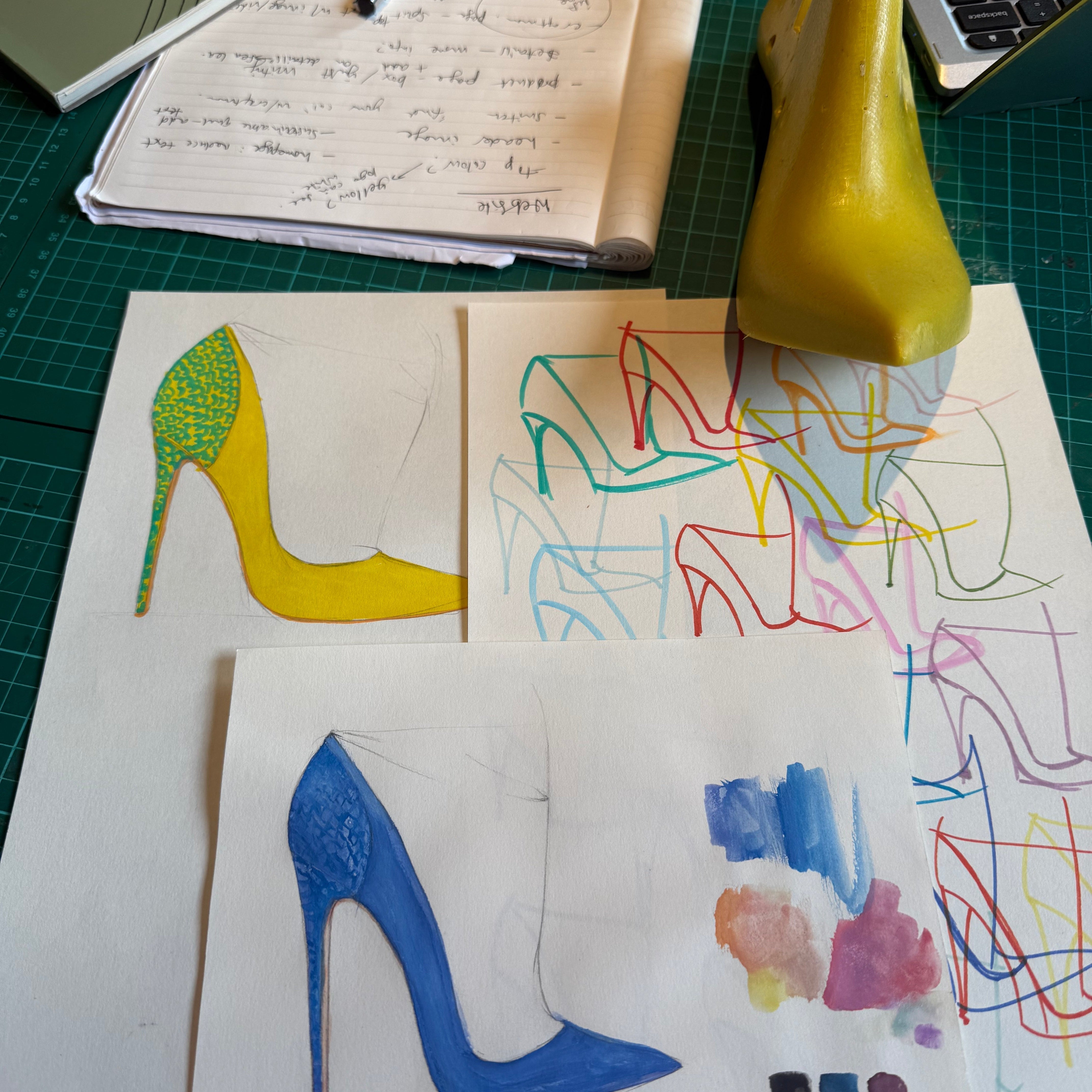 Elandetta shoe design sketches and colour studies featuring yellow and blue pointed heels, shown alongside hand-drawn concepts and materials during the creative development process behind the luxury collection.