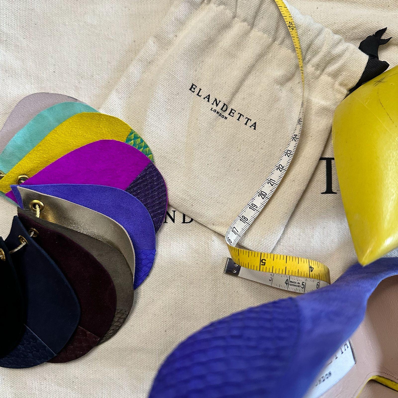 Elandetta luxury shoe swatch book featuring colourful suede and leather samples, a British-designed high heel, measuring tape and branded dust bag, helping customers choose shoe colours confidently when shopping online.