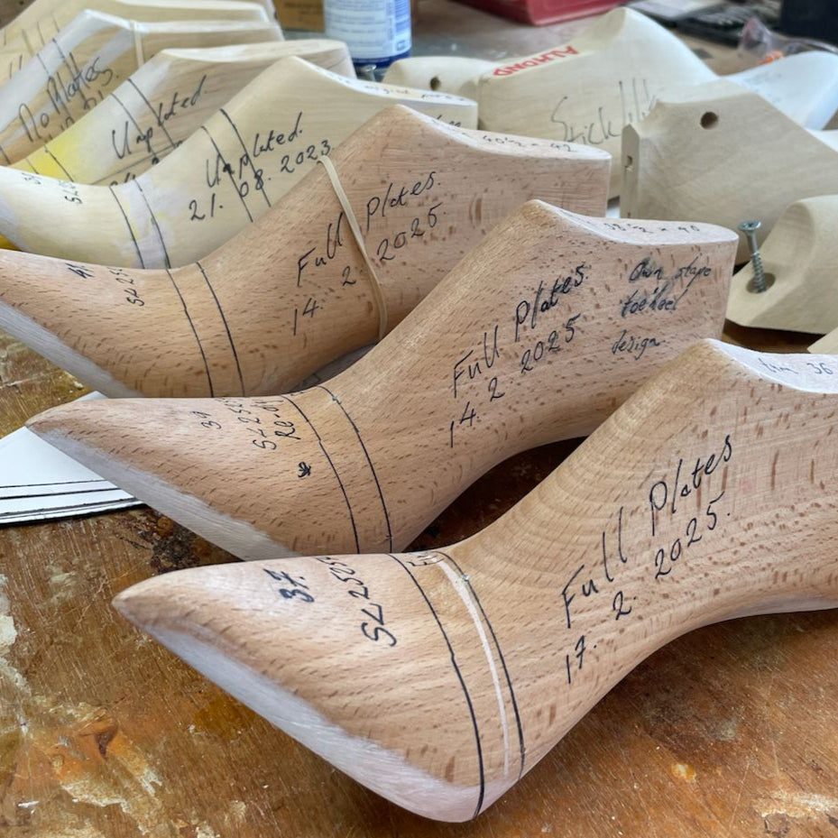 Wooden Elandetta pointed high heel shoe lasts from Northampton on a wooden work desk