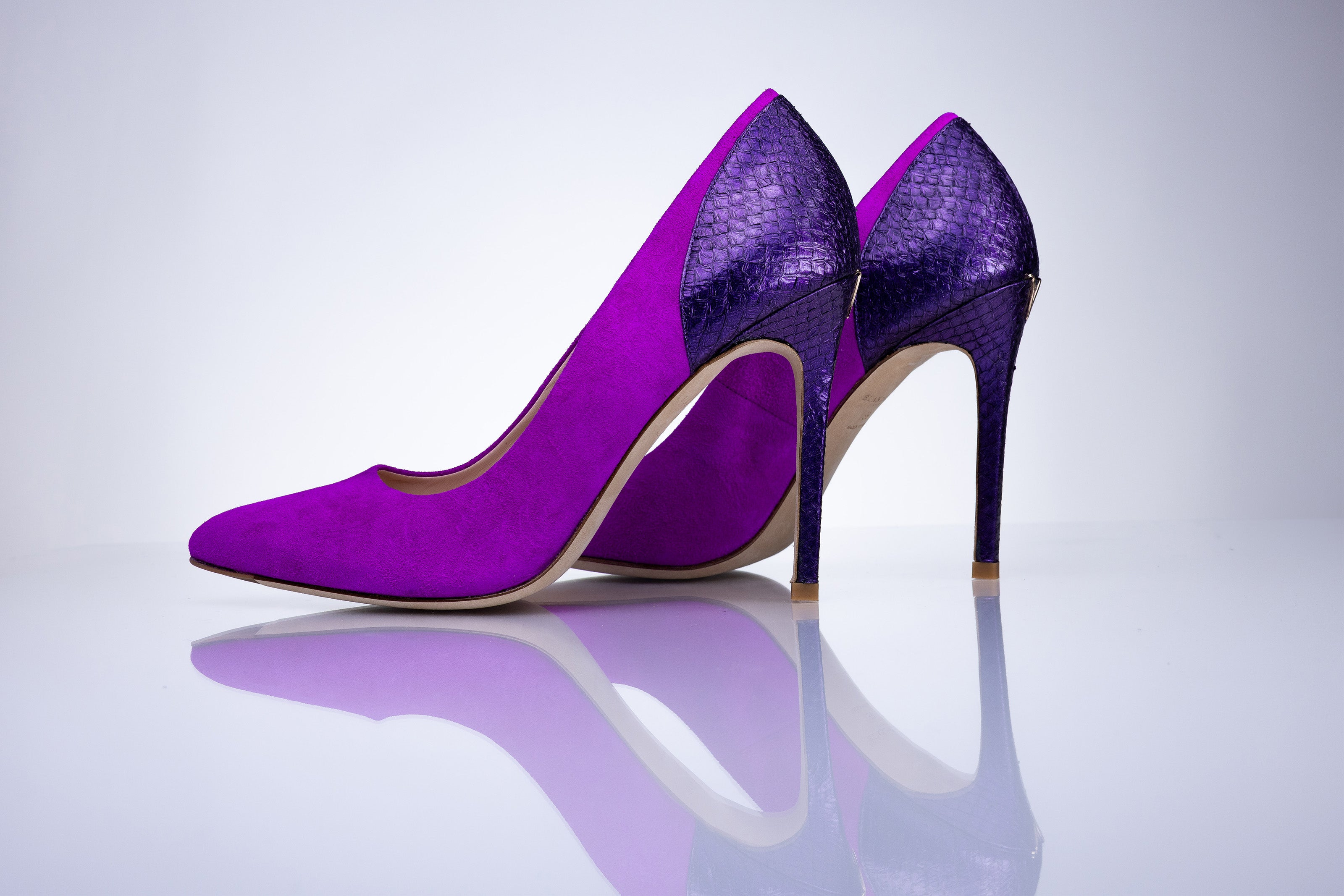 Rear view of Elandetta Amethyst heels highlighting dark violet textured leather detailing and sculpted heel silhouette.