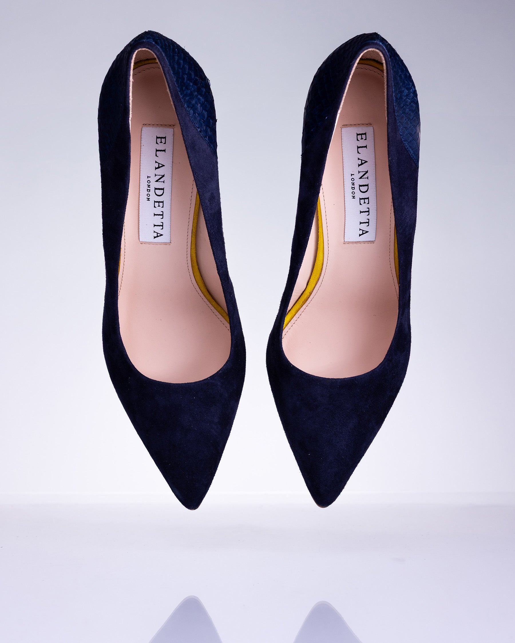 Pair of Elandetta Baltic Blue deep navy suede pointed heels with textured leather detailing and elegant silhouette.