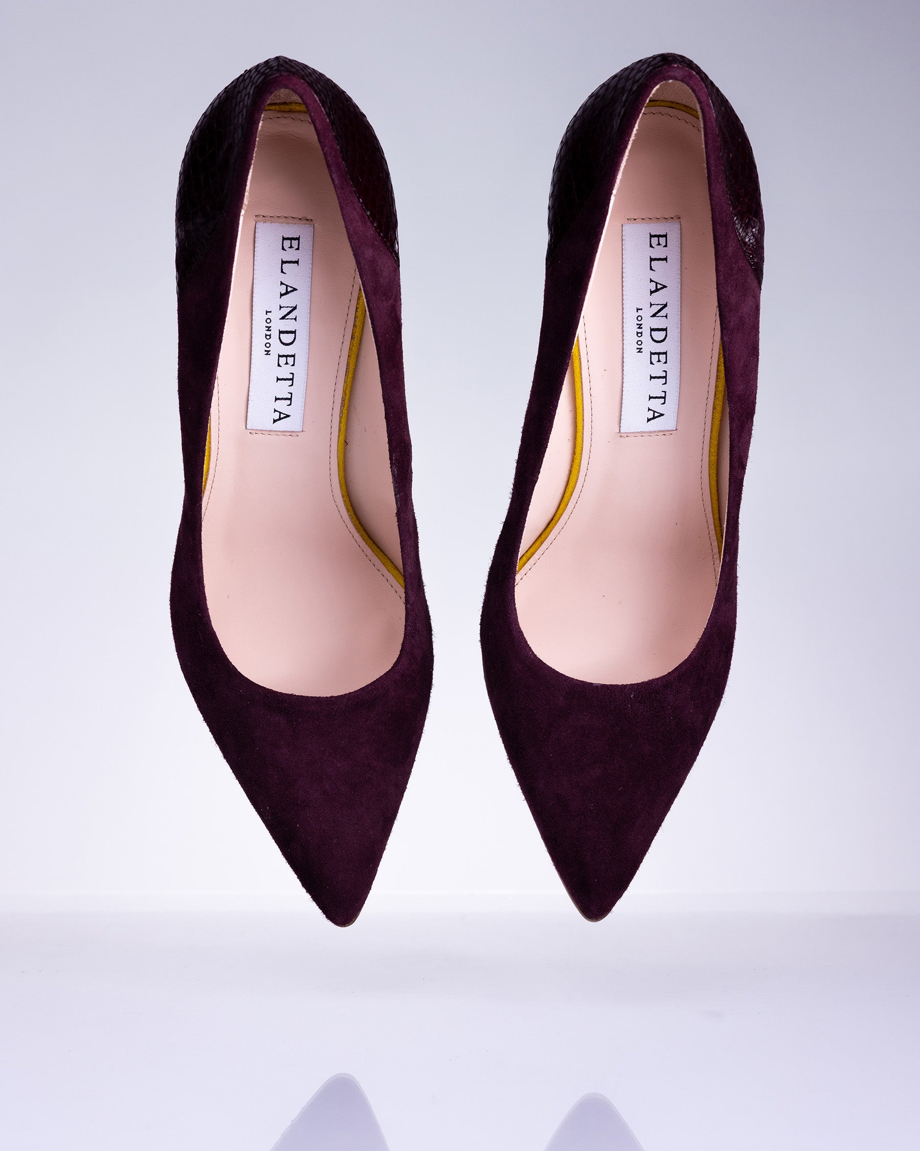 Pair of Elandetta Bordeaux deep burgundy suede pointed heels with textured leather detailing and elegant silhouette.