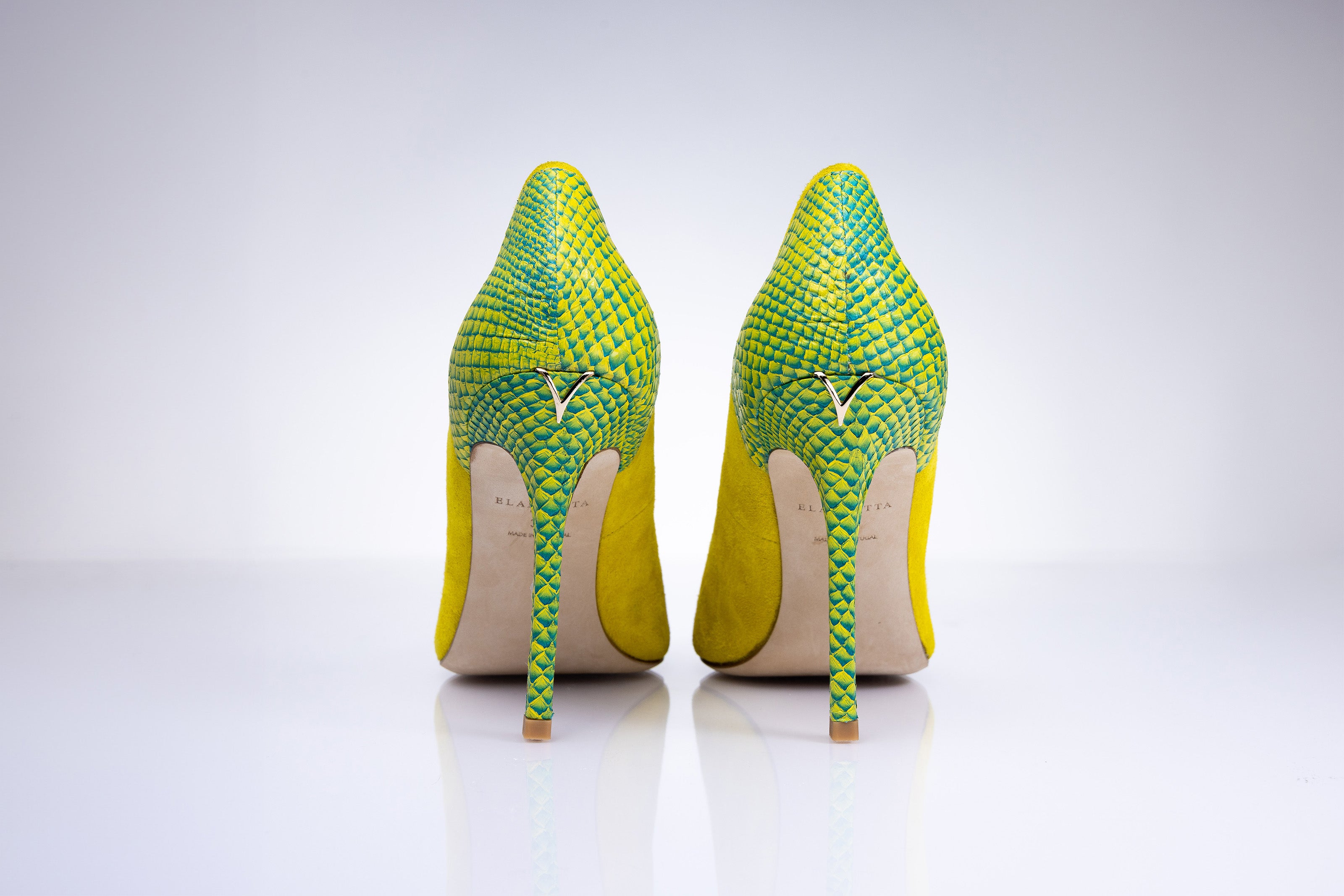 Rear angle of Elandetta Bouee heels highlighting green textured leather detailing and slim heel silhouette.