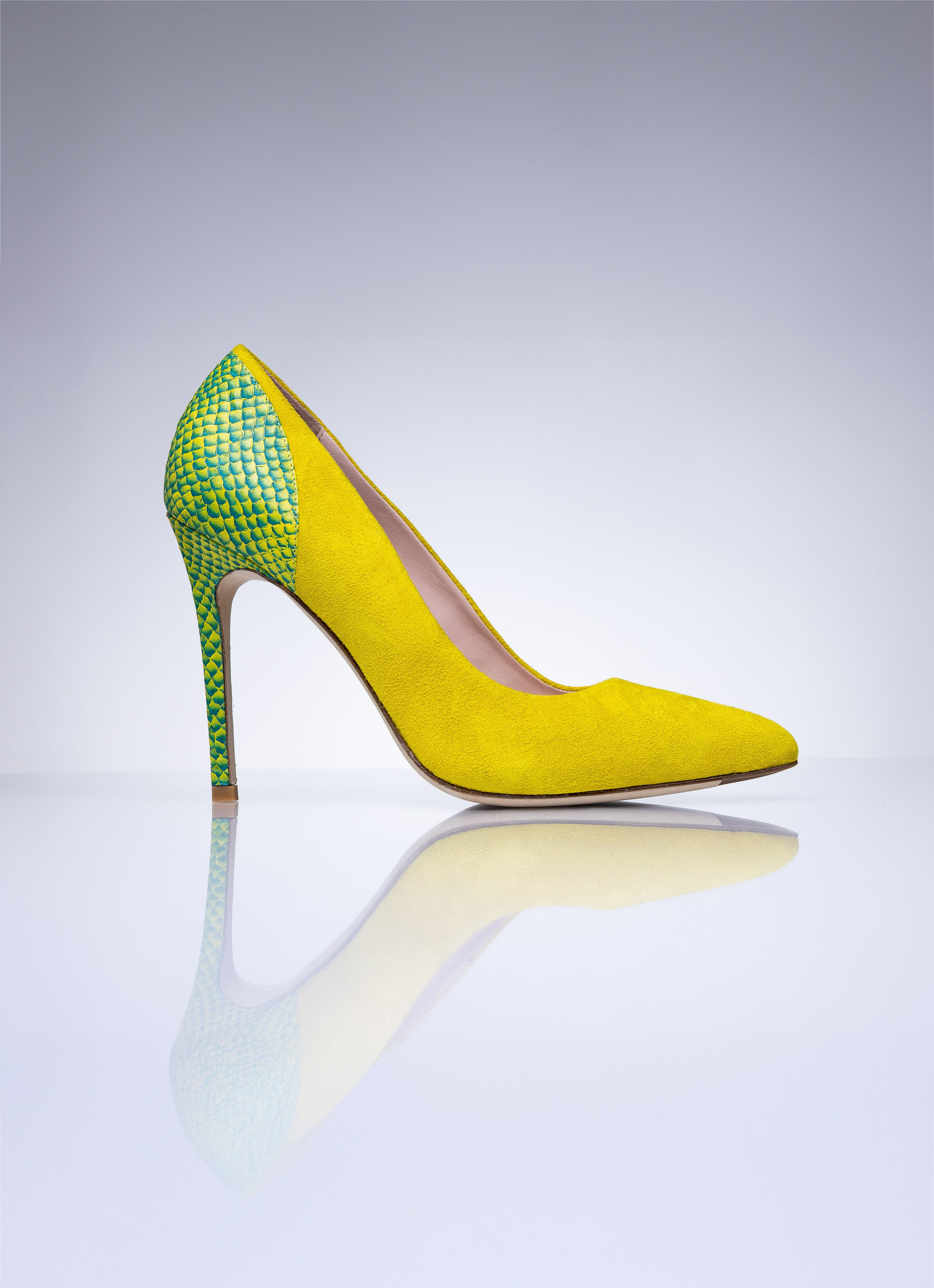 Pair of Elandetta Bouee yellow suede heels featuring pointed toes and green textured leather heel detail.