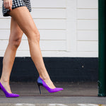 Model wearing Elandetta Amethyst purple pink suede heels styled for bold modern luxury fashion.