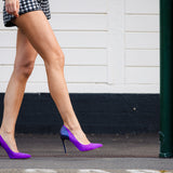 Model wearing Elandetta Amethyst purple pink suede heels styled for bold modern luxury fashion.