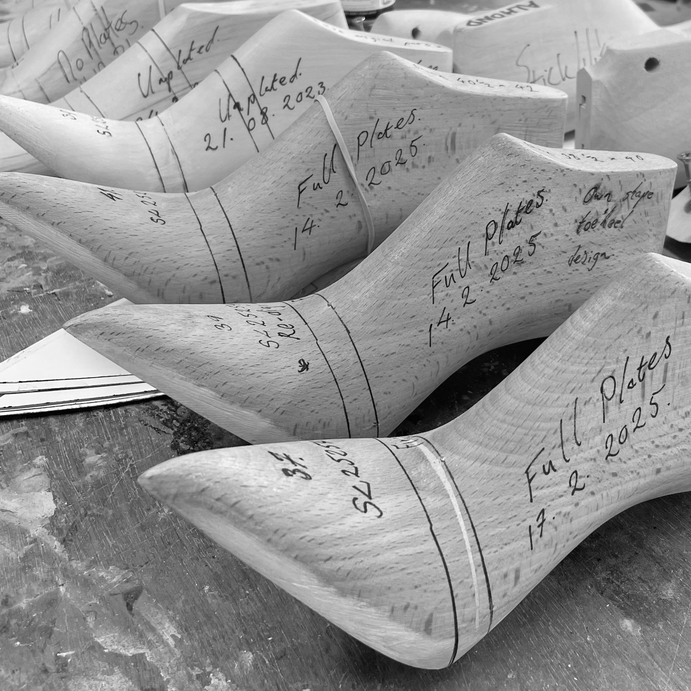 Traditional wooden shoemaking lasts used in the development of Elandetta luxury pointed heels, marked with handwritten notes from the design process. The image highlights the craftsmanship, precision, fit development and artisanal shoemaking techniques behind Elandetta’s colour-led footwear collection.