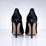 Rear view of Elandetta Ink heels highlighting textured black leather detailing and signature heel silhouette.