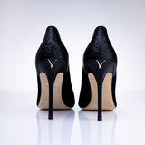 Rear view of Elandetta Ink heels highlighting textured black leather detailing and signature heel silhouette.