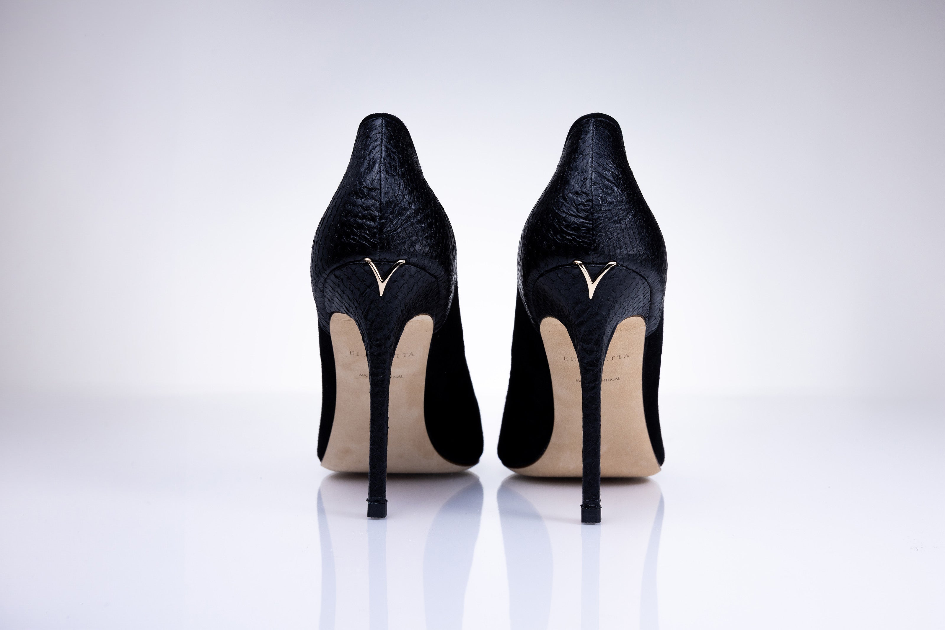 Rear view of Elandetta Ink heels highlighting textured black leather detailing and signature heel silhouette.