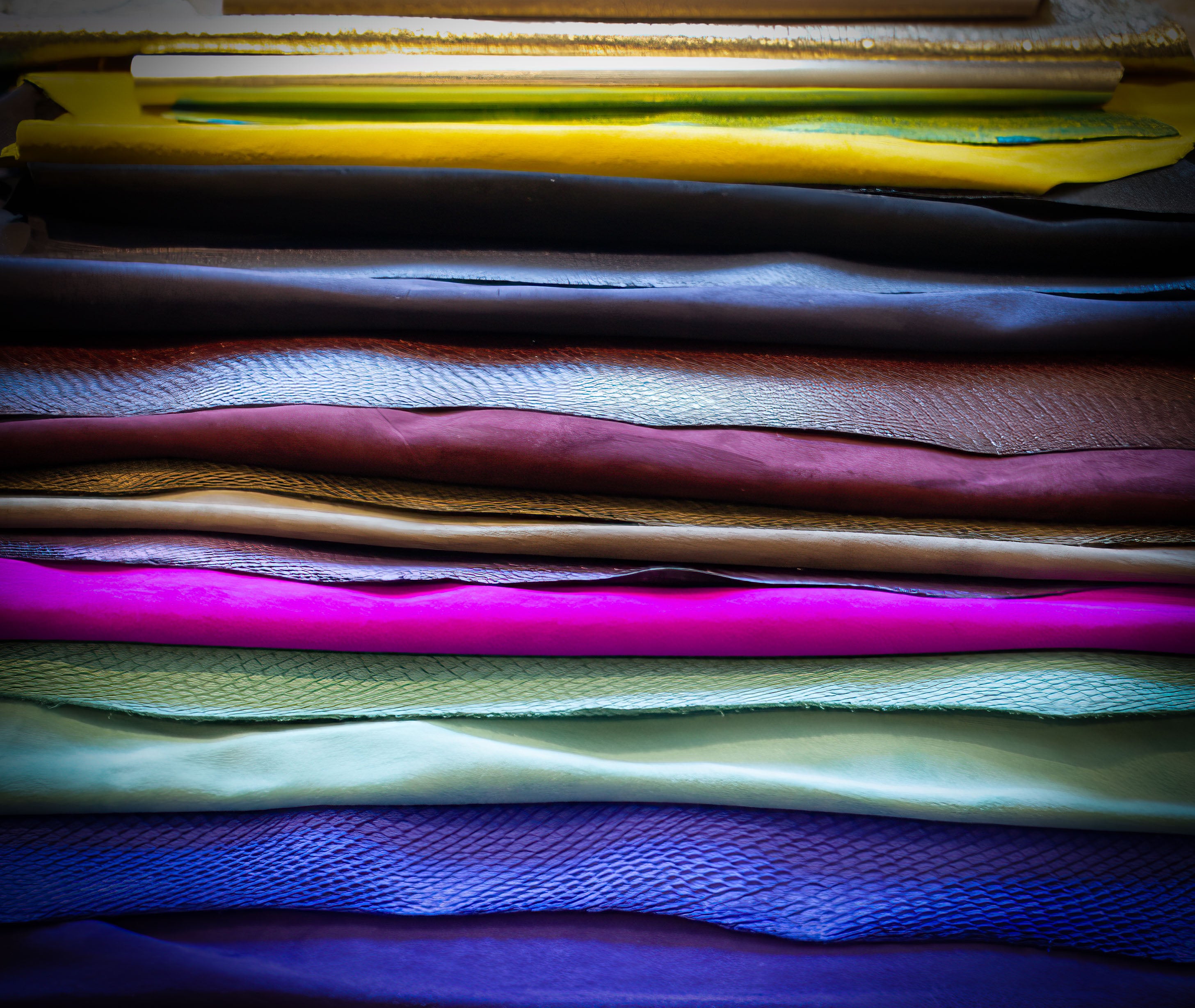 Stacked leather and suede swatches in bold colours including electric blue, pink, yellow, aqua and metallic finishes used in the development of Elandetta luxury heels. Elandetta’s swatch system is designed to help women choose shoe colour with confidence while experiencing the craftsmanship and materials before purchasing online.