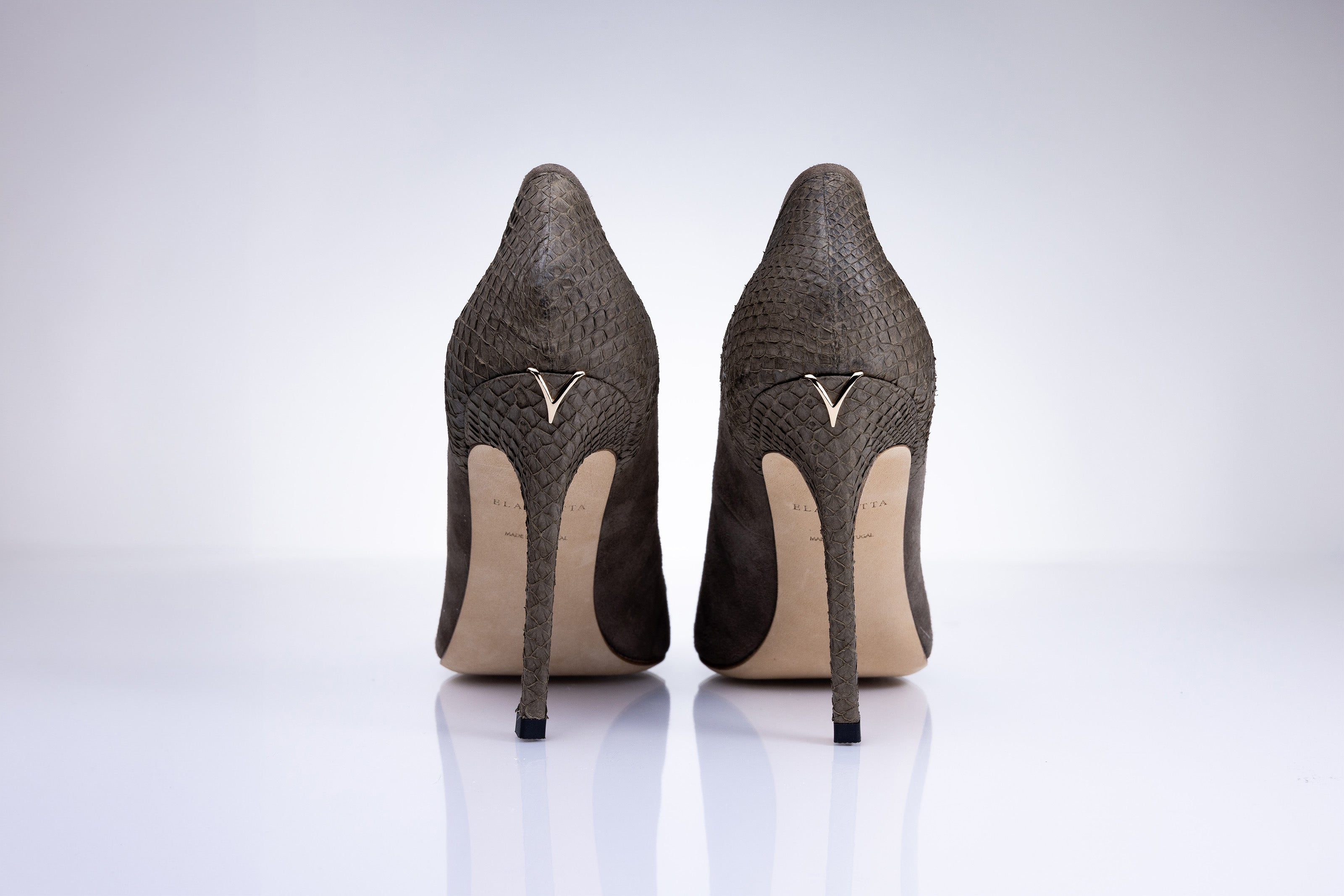 Rear view of Elandetta Moka heels highlighting textured taupe leather detailing and signature heel silhouette.