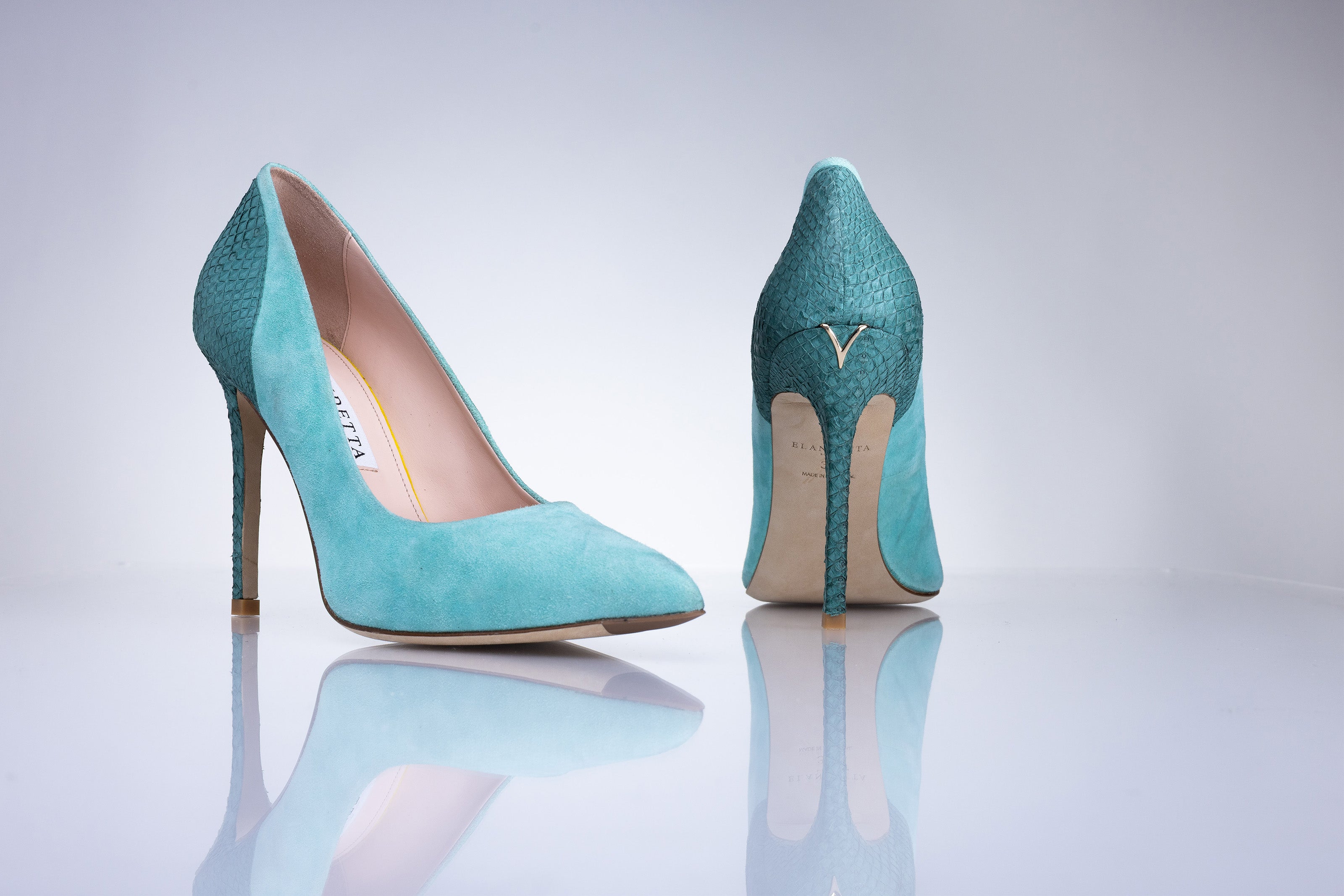 Side profile of the Elandetta Sage Green suede heel featuring aqua blue undertones and slim stiletto heel.
