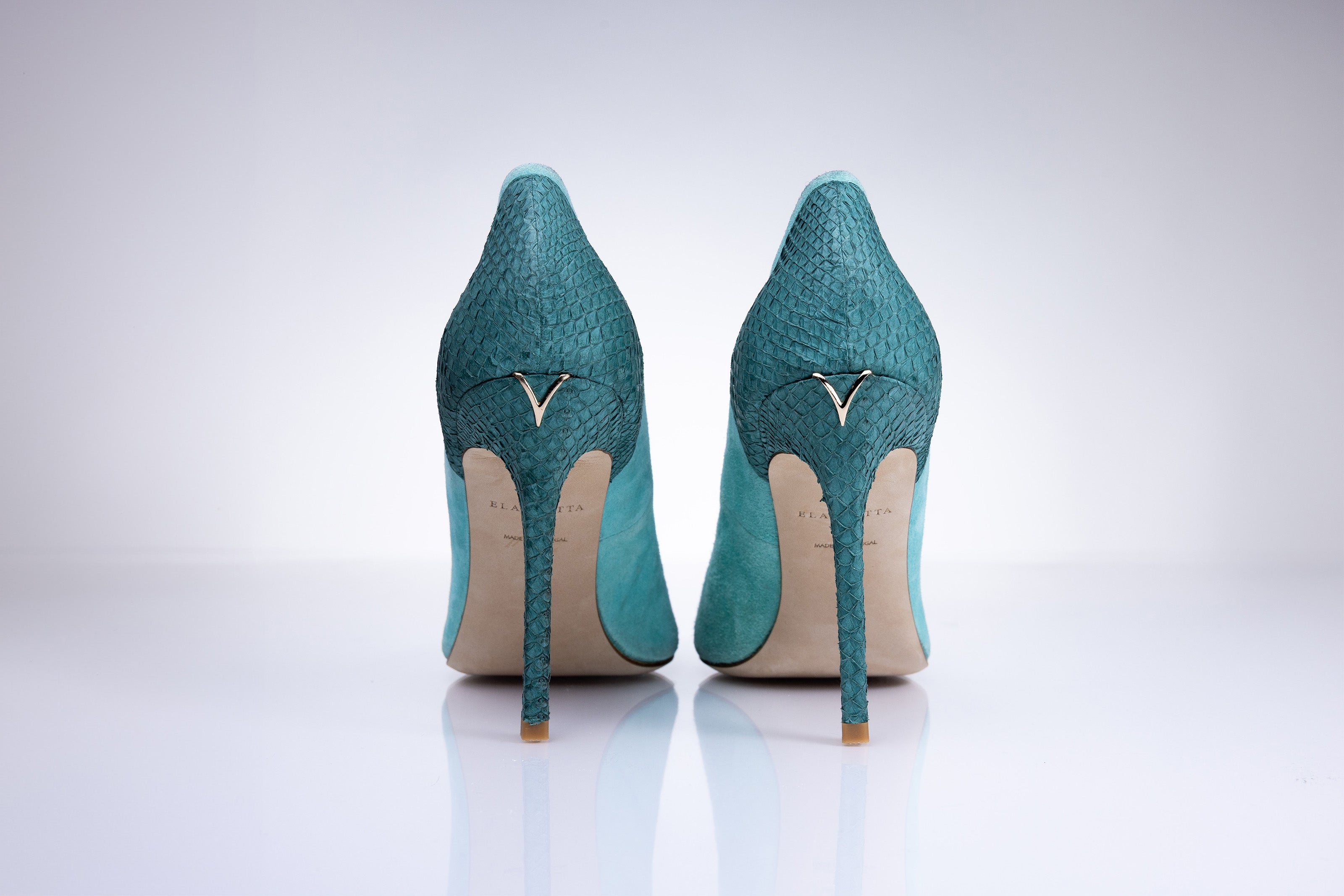 Rear view of Elandetta Sage Green heels highlighting aqua green textured leather detailing and signature heel silhouette.