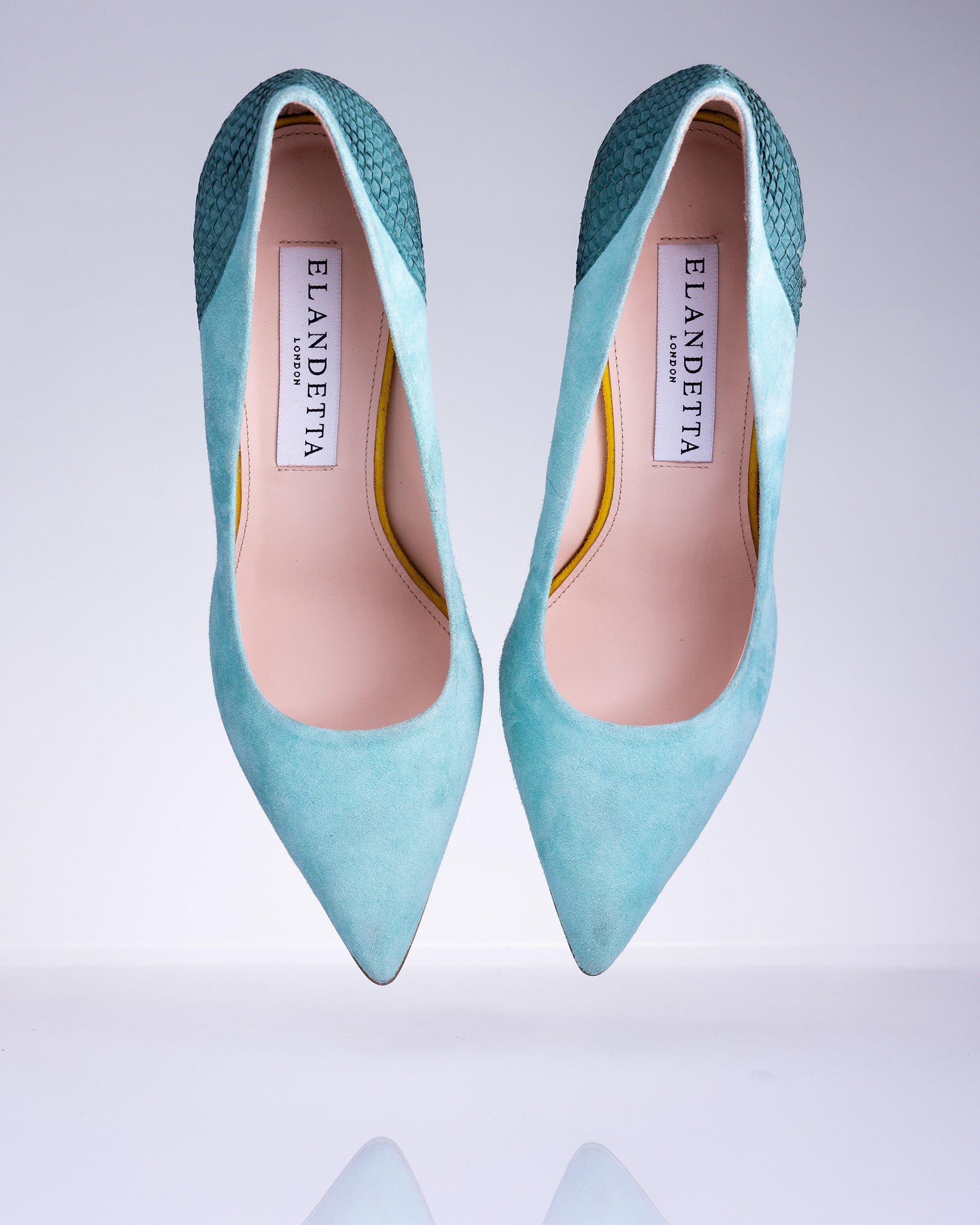 Pair of Elandetta Sage Green suede pointed heels with soft aqua blue undertones and textured leather detailing.