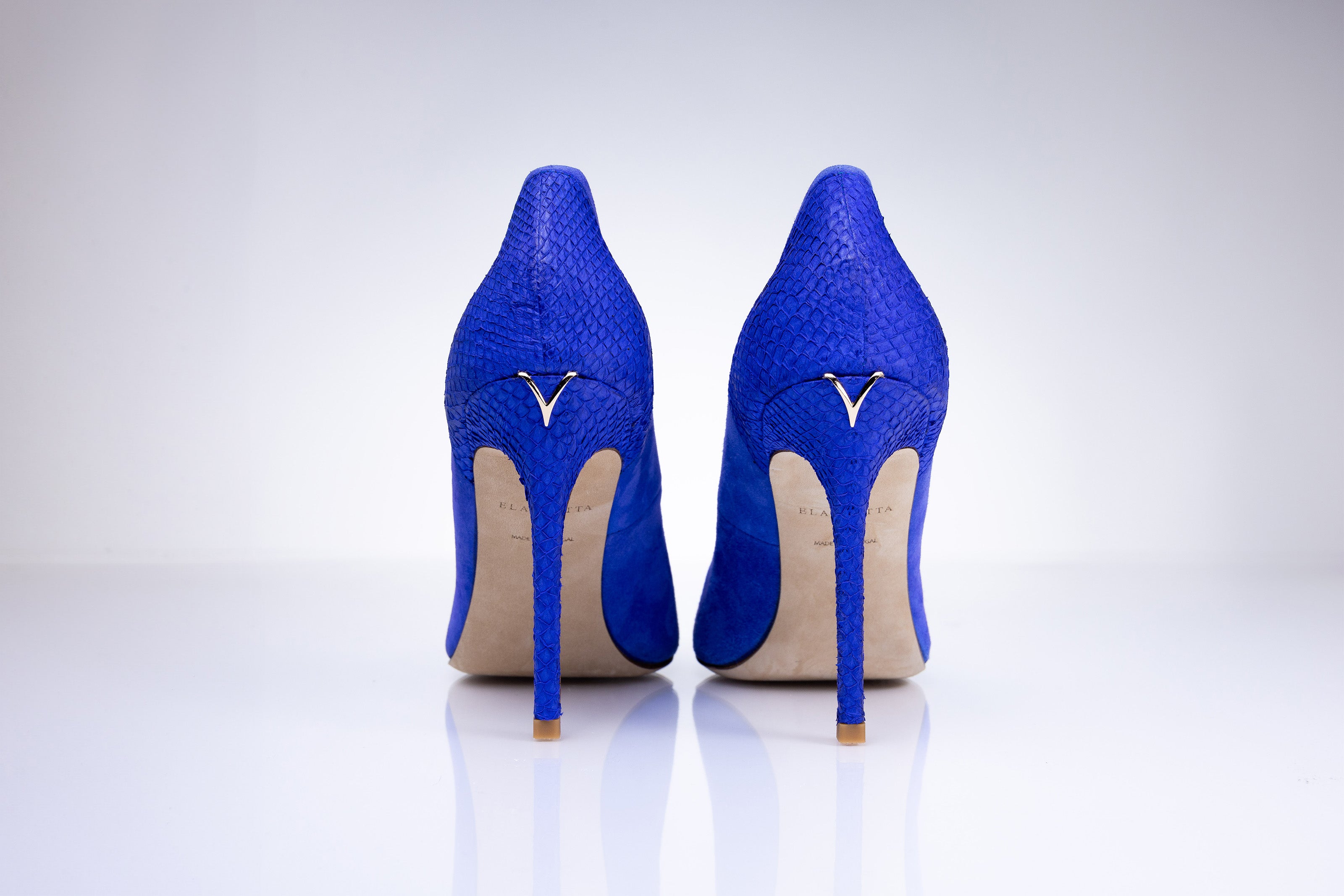 Rear view of Elandetta Ultraviolet electric blue suede heels featuring sleek stiletto heels and signature detailing.