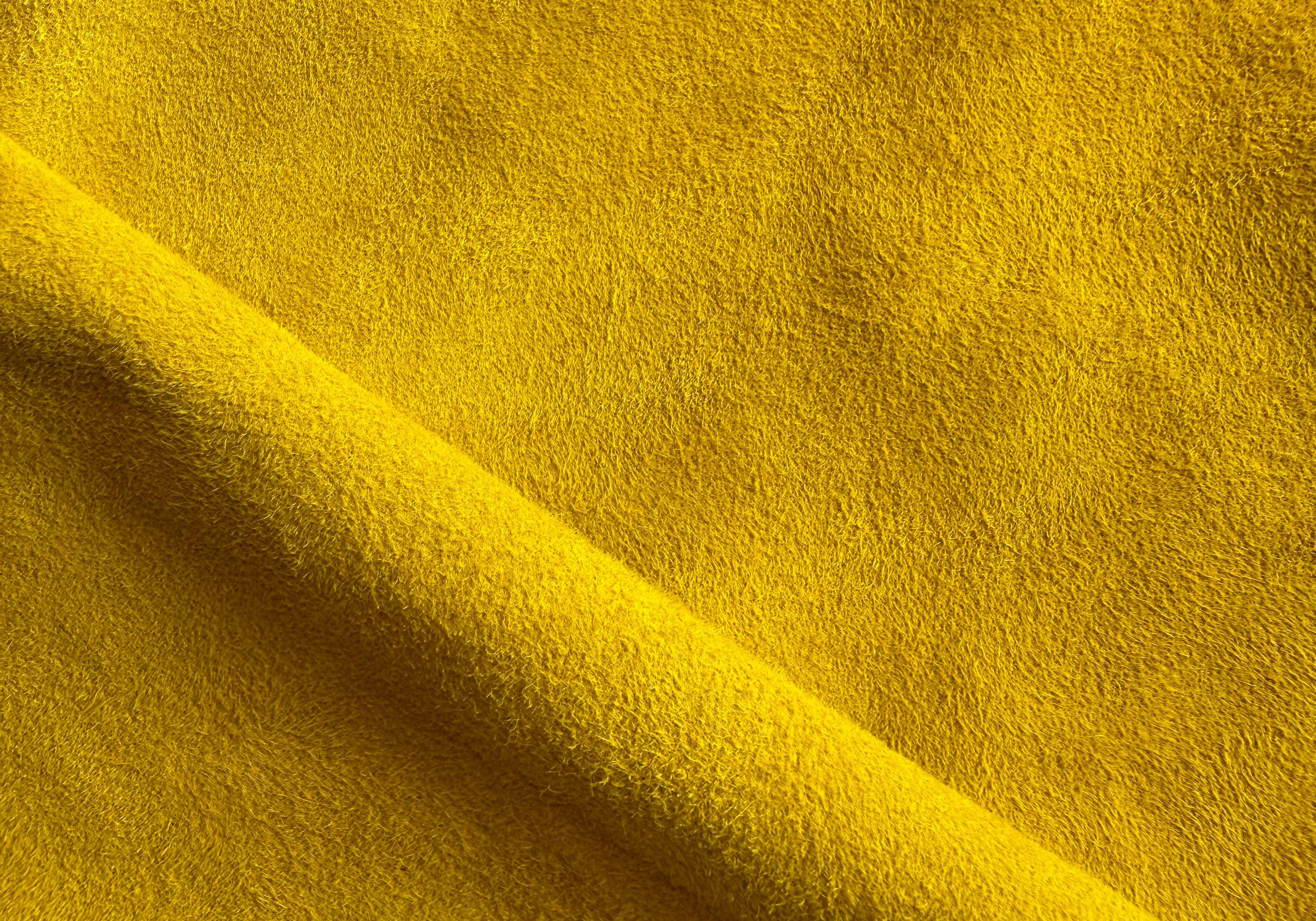 Close-up of vibrant yellow suede leather used in Elandetta luxury heels, highlighting rich colour, soft texture and the brand’s focus on colour confidence, craftsmanship and premium materials.