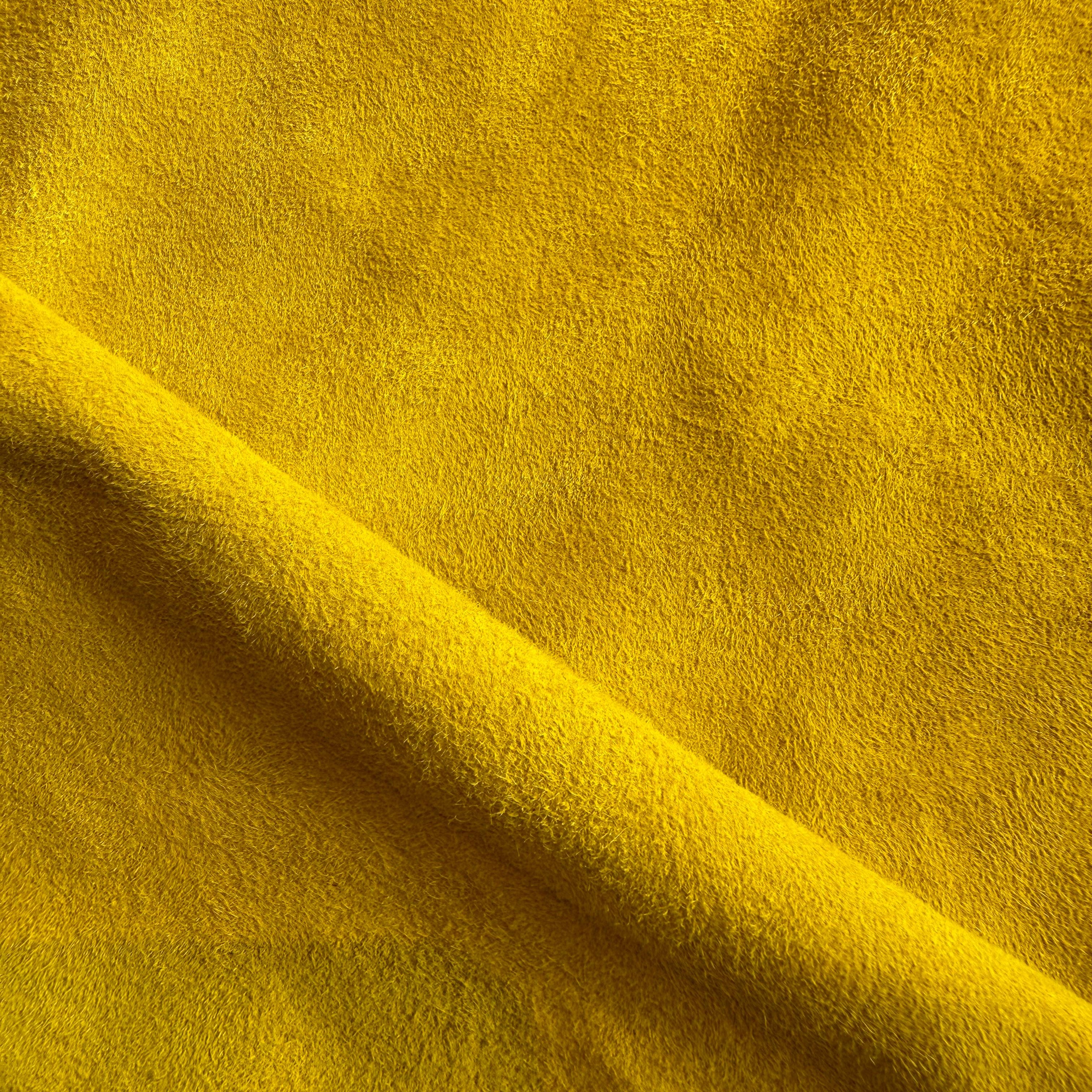 Close-up of vibrant yellow suede leather used in Elandetta luxury heels, highlighting rich colour, soft texture and the brand’s focus on colour confidence, craftsmanship and premium materials.