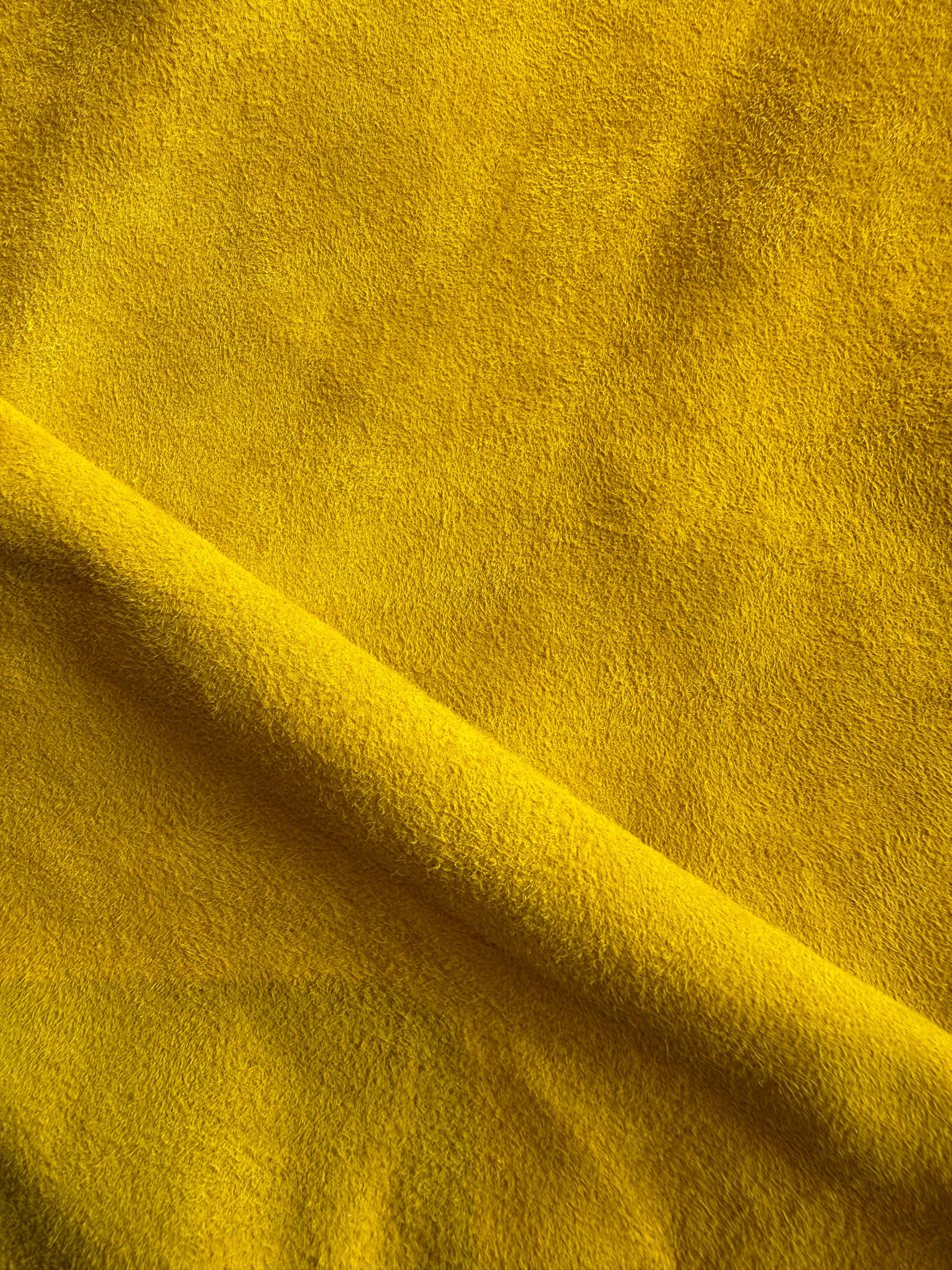 Close-up of vibrant yellow suede leather used in Elandetta luxury heels, highlighting rich colour, soft texture and the brand’s focus on colour confidence, craftsmanship and premium materials.