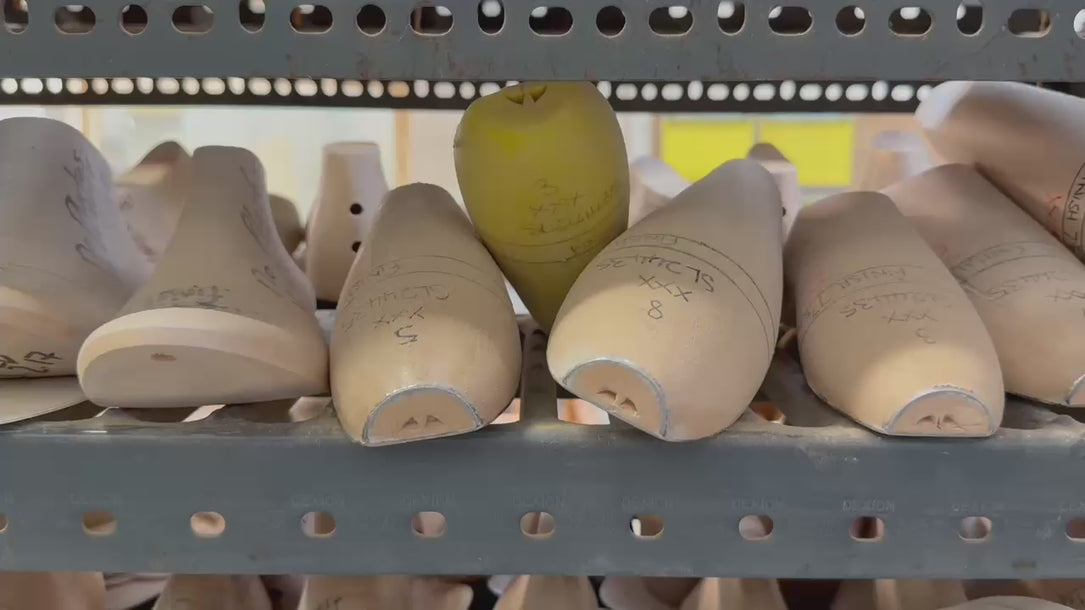 Video showing traditional shoemaking lasts used in the creation of Elandetta luxury pointed heels. Wooden shoe forms line workshop shelves, highlighting the craftsmanship, precision and artistry behind Elandetta’s colour-led British footwear design process.